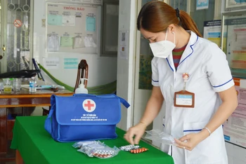 Nhân viên y tế xã Bình Thành, huyện Thanh Bình, Đồng Tháp chuẩn bị túi thuốc cho F0 điều trị tại nhà.