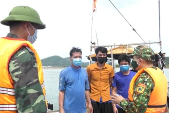 Cán bộ Đồn Biên phòng cửa khẩu cảng Cửa Lò-Bến Thủy tuyên truyền phòng, chống dịch đến ngư dân ở ngay trên các phương tiện.