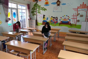 Giáo viên Trường Tiểu học Lê Lợi, thành phố Hà Giang khử khuẩn phòng học sau khi cho học sinh nghỉ học trực tiếp.