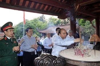 Chủ tịch nước Nguyễn Xuân Phúc dâng hương tại đền thờ Đức Quốc Tổ Lạc Long Quân. (Ảnh: Thống Nhất/TTXVN)