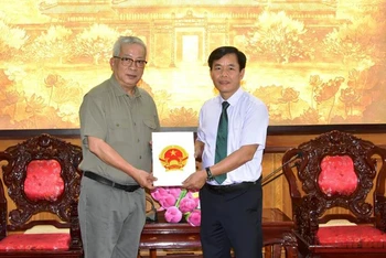 Chủ tịch Ủy ban nhân dân tỉnh Thừa Thiên Huế Nguyễn Văn Phương trao quyết định cho ông Nguyễn Chí Vịnh - đại diện gia đình Đại tướng Nguyễn Chí Thanh.