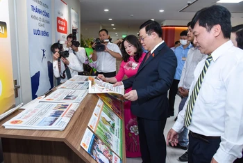 Chủ tịch Quốc hội Vương Đình Huệ xem các ấn phẩm của báo Đại biểu Nhân dân. (Ảnh Duy Linh)