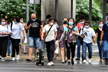 Người dân Singapore đi bộ trên phố ngày 14/5/2021. (Ảnh: REUTERS)