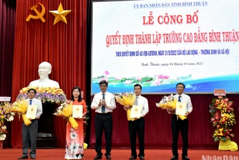 Phó Chủ tịch Ủy ban nhân dân tỉnh Bình Thuận Nguyễn Minh (đứng giữa) tặng hoa chúc mừng Ban Giám hiệu Trường Cao đẳng Bình Thuận.