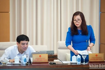 Phó Chủ nhiệm Ủy ban Tài chính, Ngân sách Vũ Thị Lưu Mai báo cáo thẩm tra dự thảo Nghị quyết của Quốc hội về thí điểm một số cơ chế, chính sách đặc thù phát triển TP Hồ Chí Minh trong phiên họp chiều 12/5. (Ảnh: DUY LINH)