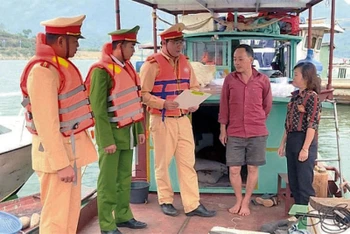 Cán bộ Đội Cảnh sát giao thông đường thủy tuyên truyền chủ phương tiện trên địa bàn thị xã Mường Lay biện pháp bảo đảm an toàn giao thông đường thủy.