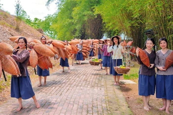 Khách du lịch trải nghiệm làm nông dân tại Khu du lịch Tuần Châu-Quốc Oai (huyện Quốc Oai).