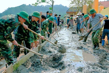 Cán bộ, chiến sĩ Đồn Biên phòng Bảo Lâm, huyện Cao Lộc giúp dân làm đường vào thôn bản.