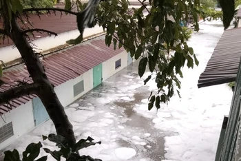 Nước với bọt trắng tràn vào khu dân cư sau mưa lớn ven suối Xiệp, phường Hóa An, thành phố Biên Hòa.