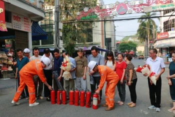 Điện lực thành phố Lào Cai tặng thiết bị chữa cháy cho bà con khu dân cư chợ Cốc Lếu.