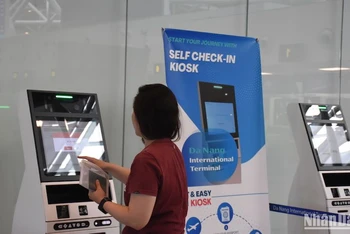 Hành khách quốc tế làm thủ tục tại quầy tự check-in (self-check-in kiosk) chiều ngày 22/4. (Ảnh: ANH ĐÀO)