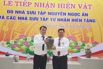 Bảo tàng Tổng hợp Quảng Bình tiếp nhận hiện vật do nhà sưu tập Nguyễn Ngọc Ẩn (bên phải) hiến tặng.