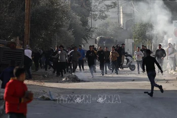 Người Palestine trong cuộc đụng độ với các lực lượng Israel tại Jenin, Bờ Tây ngày 26/1/2023. (Ảnh: THX/TTXVN)