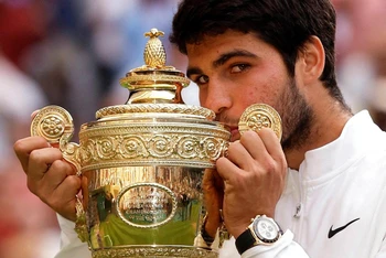 Carlos Alcaraz ăn mừng với chiếc cúp vô địch Wimbledon. (Ảnh: Reuters)