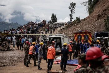 Cảnh sát Nepal đưa các nạn nhân trong vụ xe buýt bị bùn vùi lấp tại Kathmandu ra khỏi hiện trường. (Ảnh: Reuters) 