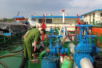 Lực lượng Công an thành phố Biên Hòa khám nghiệm khu vực trên tàu các đối tượng hút xăng để bán.