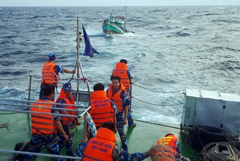 Cán bộ, chiến sĩ Bộ Tư lệnh Vùng Cảnh sát biển 4 hỗ trợ kéo tàu cá ngư dân gặp nạn vào bờ.