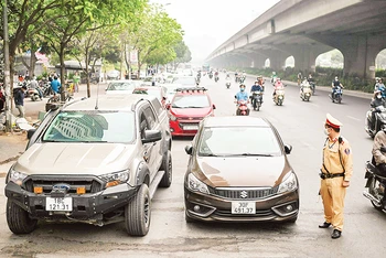 Bãi đỗ xe tự phát trên đường Nghiêm Xuân Yêm, quận Hoàng Mai. (Ảnh PHÙNG ĐÔ)