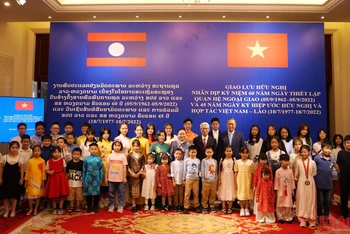 Hai Đại sứ chụp ảnh lưu niệm cùng các cháu thiếu nhi Việt Nam-Lào.