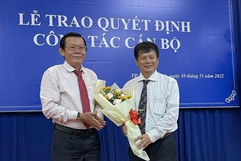 Nhà báo Trần Trọng Dũng (bên phải) trao hoa và quyết định cho nhà báo Nguyễn Tấn Phong.