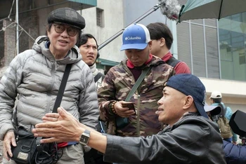 Đạo diễn Đặng Nhật Minh (ngoài cùng bên trái) chỉ đạo một cảnh quay trong phim "Hoa nhài". (Ảnh Cục Điện ảnh)