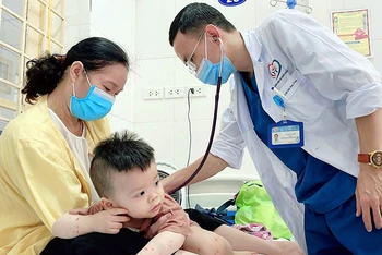 Điều trị bệnh tay chân miệng cho trẻ tại thành phố Hà Nội. (Ảnh VÂN VÂN)