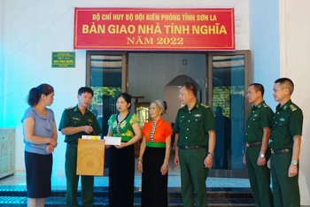 Đồng chí Đại tá Vũ Đức Tú, Phó Chính ủy Bộ đội Biên phòng tỉnh Sơn La trao tiền hỗ trợ cho gia đình liệt sĩ Hà Trọng Hưng.