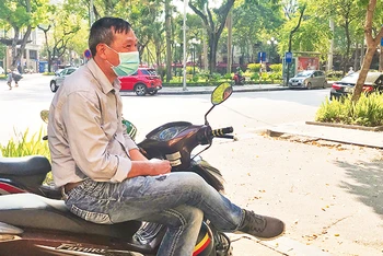 Anh Nguyễn Đức Hùng, làm nghề lái xe ôm (trú tại phố Nguyễn Khoái, quận Hai Bà Trưng) ngồi đợi khách dưới trời nắng nóng. 