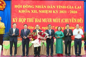 Đại diện lãnh đạo Tỉnh ủy, Hội đồng nhân dân, Ủy ban nhân dân tỉnh tặng hoa chúc mừng đồng chí Rah Lan Chung.