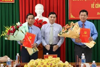 Phó Bí thư Thường trực Tỉnh ủy Bình Thuận Nguyễn Hoài Anh (giữa) tặng hoa chúc mừng đồng chí Võ Thanh Bình (bên trái hình) và đồng chí Tiêu Hồng Phúc. 