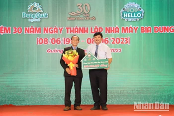 Lãnh đạo Nhà máy Bia Dung Quất trao biểu trưng tặng 200 triệu đồng hỗ trợ xây dựng nhà đại đoàn kết cho người nghèo Quảng Ngãi.