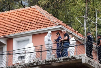 Công tố viên và nhân viên pháp y làm việc tại ngôi nhà xảy ra án mạng ở thành phố Cetinje. (Ảnh: Reuters)