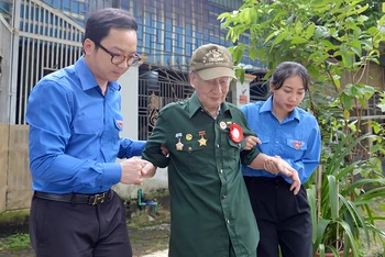 Các cán bộ đoàn đưa cựu chiến binh Nguyễn Phương Ðàn (99 tuổi, trú phường Noong Bua, thành phố Ðiện Biên Phủ, tỉnh Ðiện Biên) đi thăm lại chiến trường năm xưa.