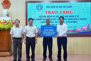 Tổng Giám đốc Bảo hiểm xã hội Việt Nam Nguyễn Thế Mạnh trao tặng sổ bảo hiểm xã hội, thẻ bảo hiểm y tế cho các địa phương của tỉnh Quảng Bình, tháng 7/2023. (Ảnh: TÂM TRUNG)