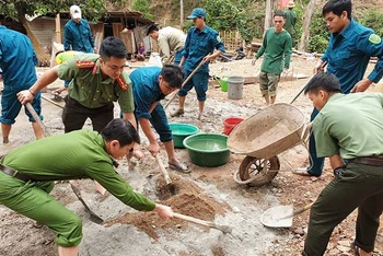 Công an huyện Tương Dương (Nghệ An) cùng lực lượng dân quân hỗ trợ người dân làm móng nhà ở xã Xiêng My.