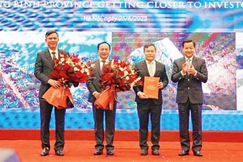 Phó Thủ tướng Lê Minh Khái trao Quyết định phê duyệt quy hoạch tỉnh Quảng Bình giai đoạn 2021-2030, tầm nhìn đến năm 2050 cho lãnh đạo tỉnh.