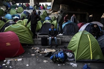 Người di cư chuẩn bị được sơ tán. (Ảnh: AFP/TTXVN)