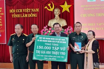 Ban tổ chức trao bảng tượng trưng cho Hội Cựu chiến binh tỉnh Lâm Đồng tặng 150 nghìn tập vở cho học sinh địa phương.