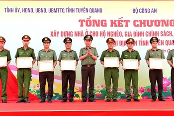 Đại tướng Tô Lâm, Ủy viên Bộ Chính trị, Bộ trưởng Công an trao bằng khen cho các tập thể có thành tích xuất sắc trong thực hiện Đề án xóa nhà ở tạm, dột nát cho hộ nghèo trên địa bàn tỉnh Tuyên Quang.