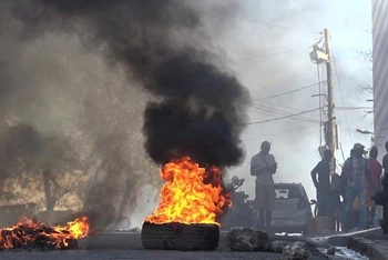 Lốp xe bốc cháy gần Nhà tù Quốc gia ở Port-au-Prince, Haiti, sau khi hàng nghìn tù nhân vượt ngục ngày 3/3. (Ảnh: AFP/TTXVN)