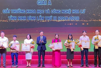 Đồng chí Đoàn Minh Huấn, Ủy viên Trung ương Đảng, Bí thư Tỉnh ủy Ninh Bình trao thưởng cho các tác giả đoạt giải A, Giải thưởng Khoa học và Công nghệ Hoa Lư lần thứ 3. (Ảnh: XUÂN TRƯỜNG) 