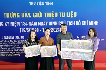 Đại diện Văn phòng Báo Nhân Dân tại Quảng Ninh tặng tranh panorama "Chiến dịch Điện Biên Phủ" cho bạn đọc.