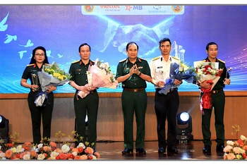 Thượng tướng Phùng Sĩ Tấn trao hoa và biểu chương tặng đại diện các đơn vị tài trợ triển lãm.