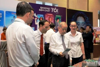 Các đại biểu trải nghiệm các sản phẩm dịch vụ tại các gian hàng trưng bày của ngân hàng.