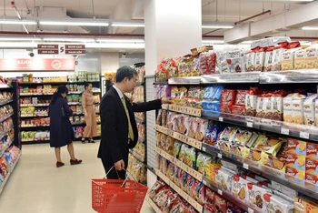Người tiêu dùng mua hàng tại siêu thị Fujimart Hà Nội. (Ảnh TUỆ NGHI)