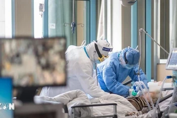 Nhân viên y tế điều trị cho bệnh nhân mắc Covid-19 tại bệnh viện ở Vũ Hán (Trung Quốc) hồi năm 2020. (Ảnh: THX/TTXVN)