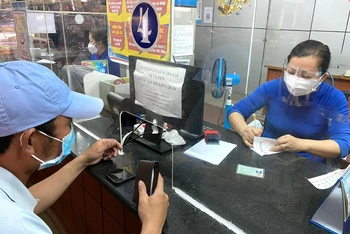Nhân viên ga Sài Gòn bán vé Tết 2022 cho hành khách.