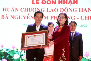 Đại diện Công ty TNHH Lan Anh (bên trái) nhận Huân chương Lao động hạng ba.