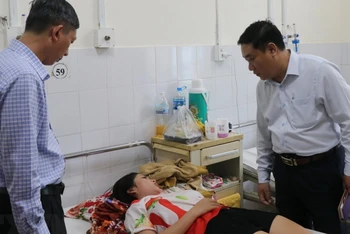 Ông Trịnh Ngọc Hiệp, Phó Giám đốc Sở Y tế tỉnh Khánh Hòa thăm hỏi bệnh nhân đang điều trị tại Bệnh viện đa khoa tỉnh Khánh Hòa. (Ảnh: Phan Sáu/TTXVN)