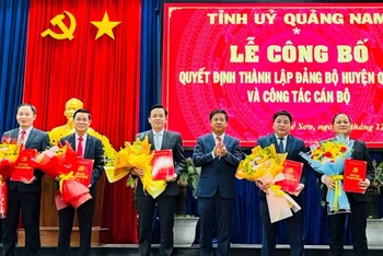 Bí thư Tỉnh ủy Lương Nguyễn Minh Triết trao quyết định, tặng hoa chúc mừng các đồng chí Thường trực Huyện ủy Quế Sơn (mới) và đồng chí Nguyễn Phước Sơn (bìa phải) nhận nhiệm vụ mới.